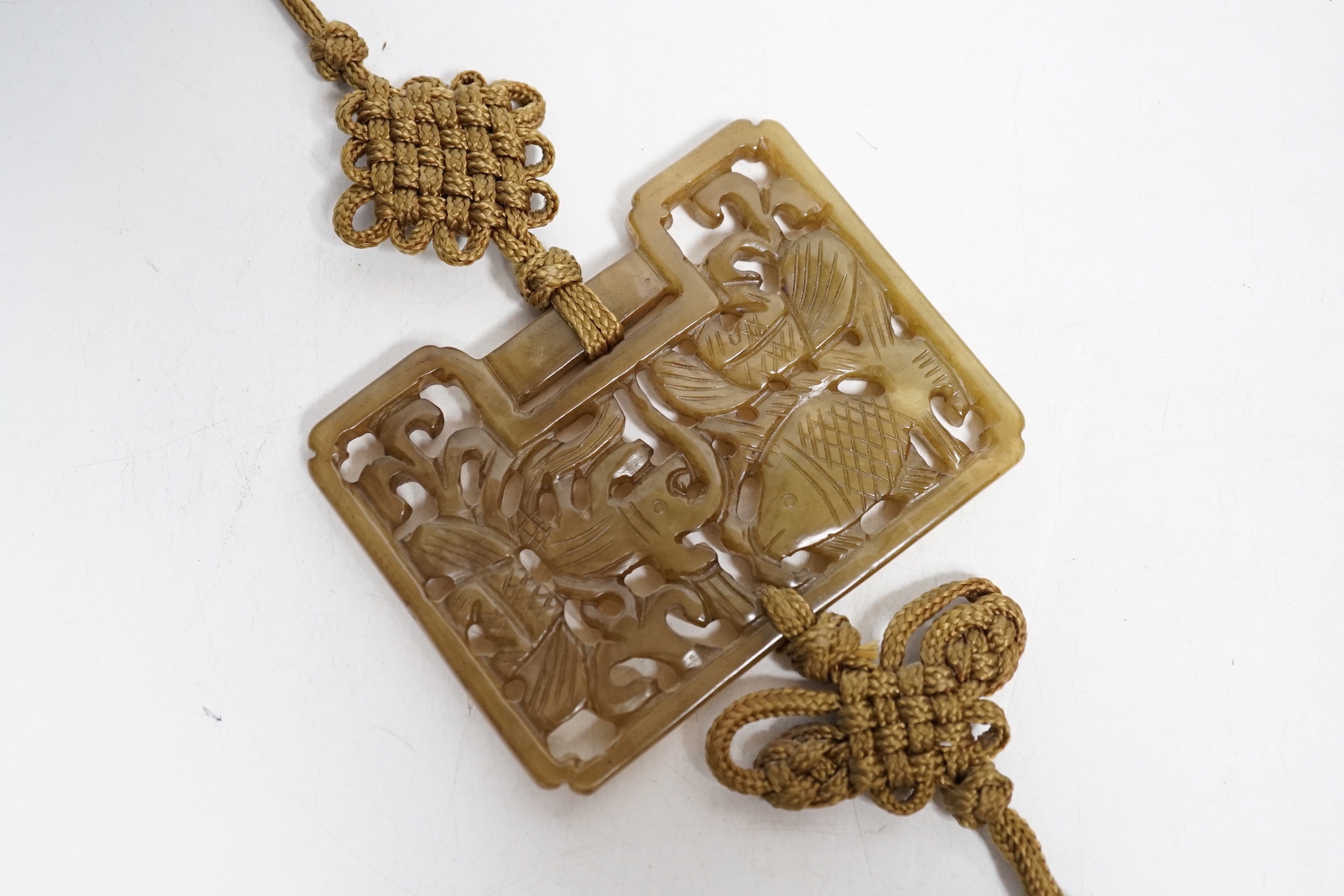 A Chinese carved jade ‘fish’ pendant, 6.5 x 9cm